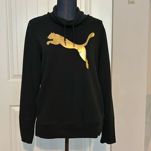 Women’s Puma black sweatshirt with large gold puma on the front.